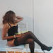 Leggy Tracey, mature New Jersey companion seated in black lingerie